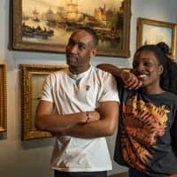 A couple visits Het Scheepvaartmuseum.