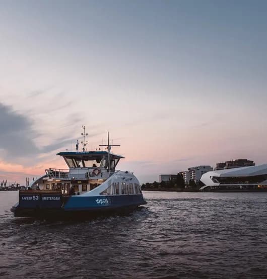 A ferry on its way to Buiksloterweg and EYE Promenade with the Eye Filmmuseum in Noord.