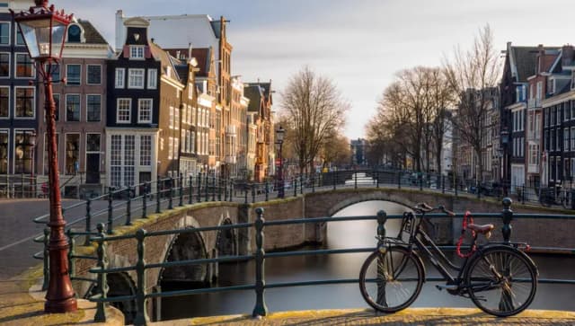 Bike parked on the bridge at Reguliersgracht in Winter