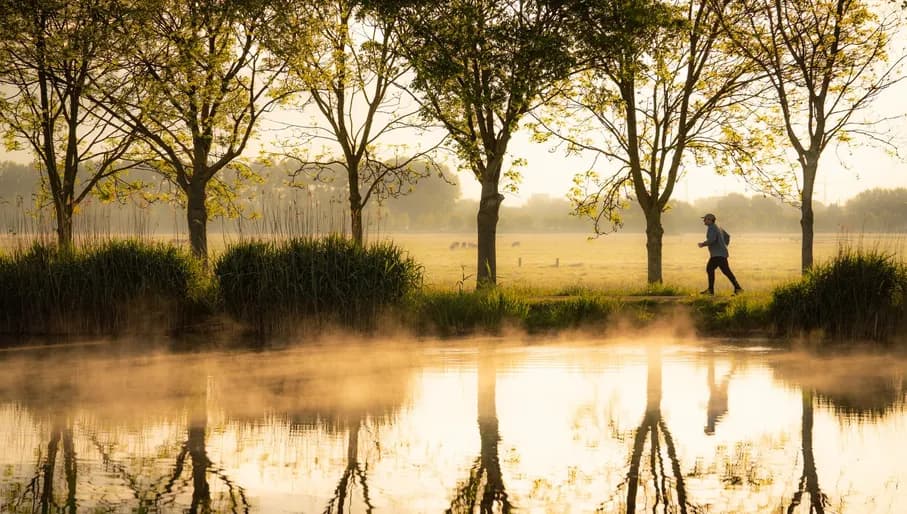 man jogging Along the Amstel river