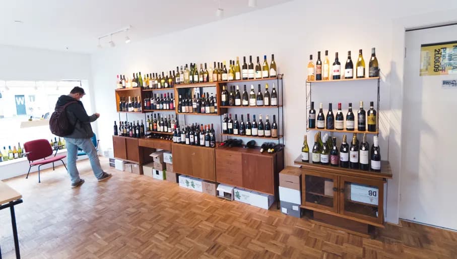 Man looking at wine in the Bureau Wijn