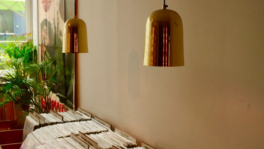 outside of shop with sign and building, outside of shop with sign and a man, inside of shop with records and record players