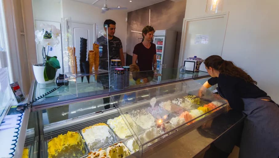 Server scoops ice cream for the customers